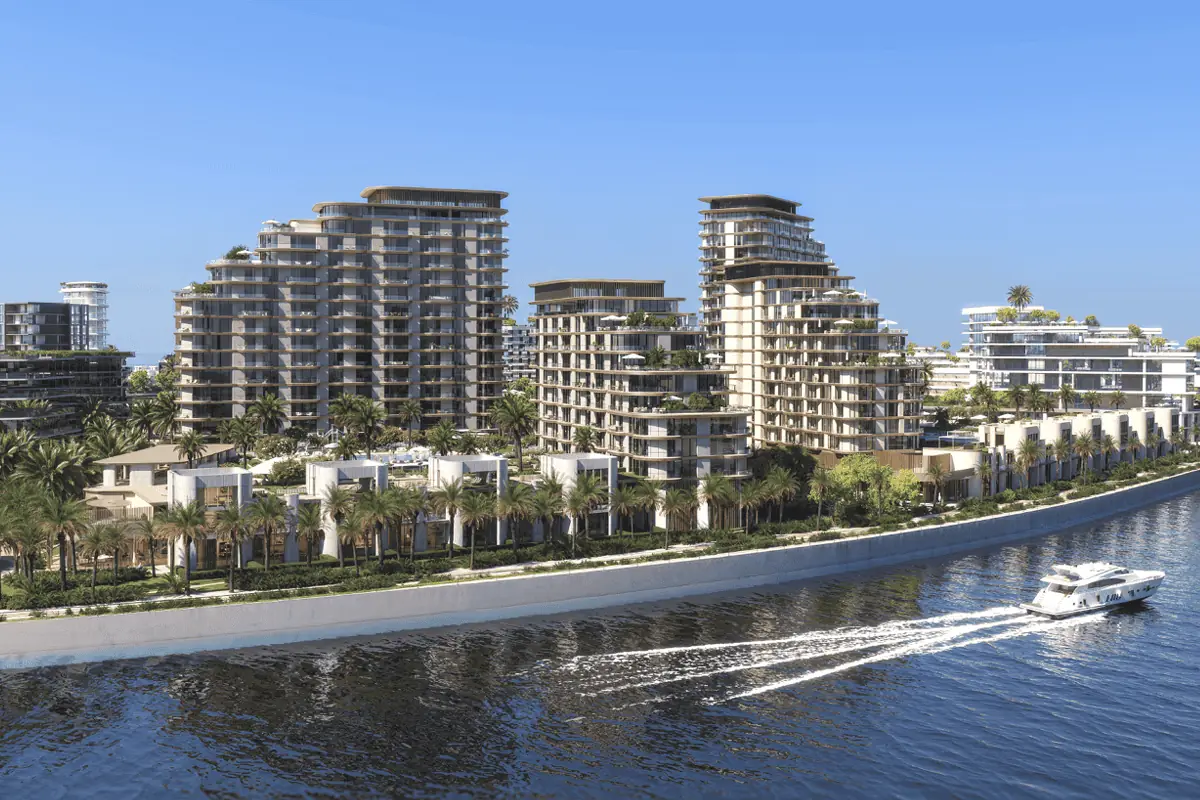 Mirasol II – waterfront buildings and villas along a canal with a passing yacht