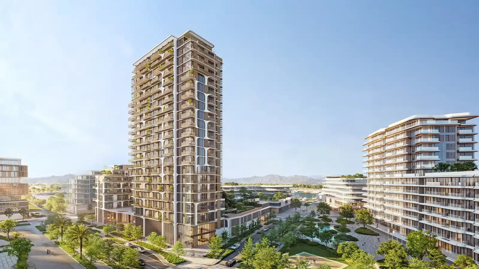 Nura – residential tower with balconies alongside landscaped grounds and mid-rise buildings