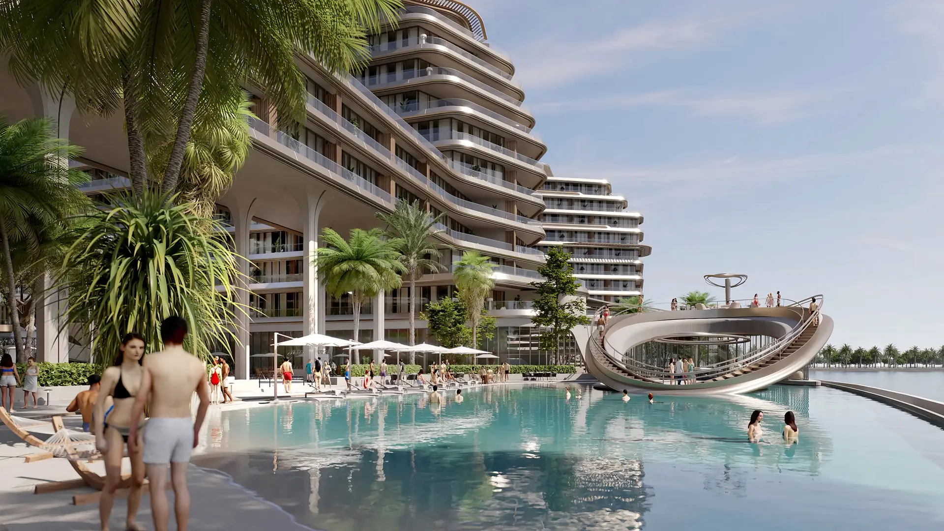 Quattro Del Mar – beach pool area beneath curved residential buildings with palm trees
